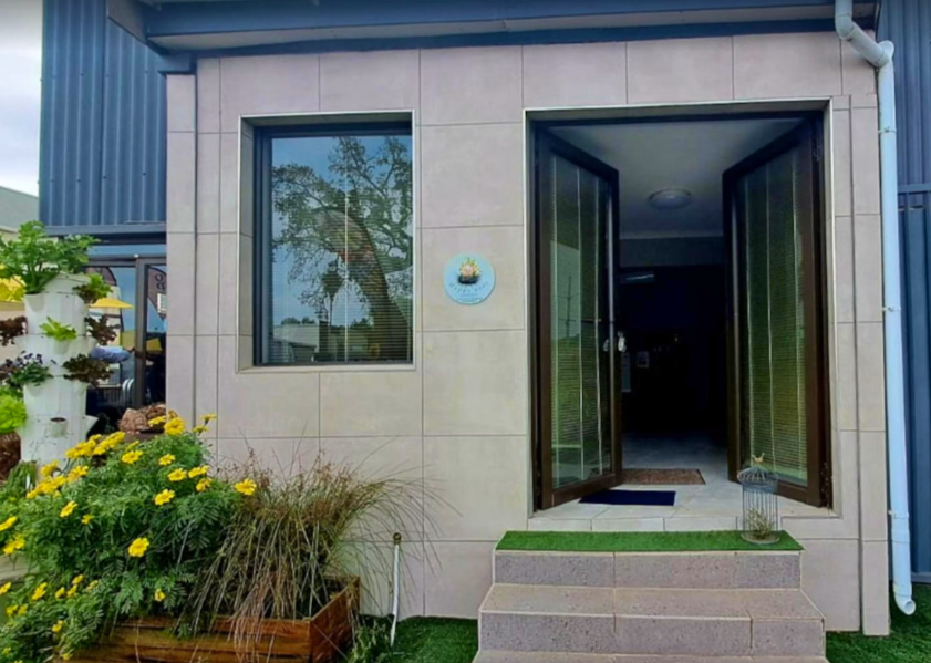 Exterior entrance with garden and flowers