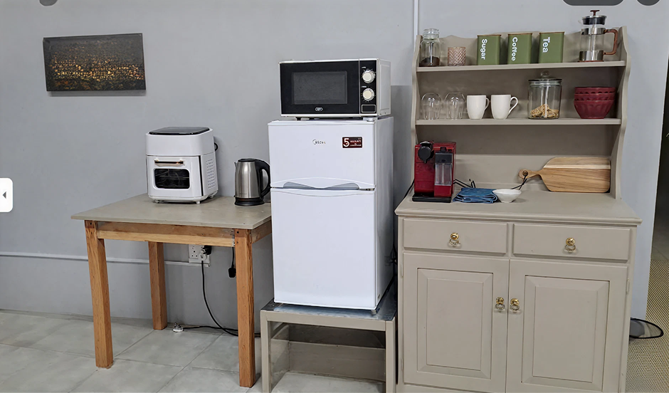 Kitchenette with appliances and coffee station