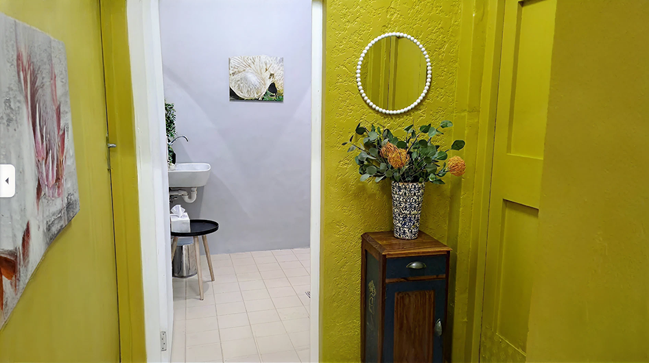 Yellow hallway leading to bathroom