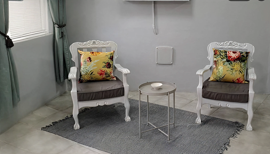 Elegant sitting area with floral cushions and rug